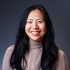 Head shot of Reese Lee, an Asian woman with long black hair and a big grin.