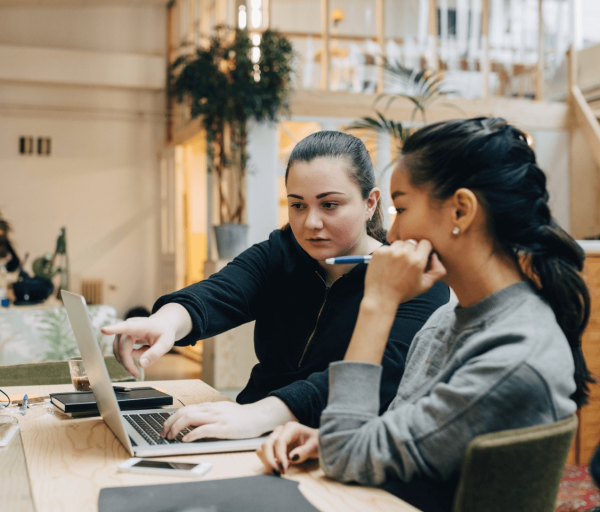 Two developers working to diagnose a problem using Prometheus monitoring
