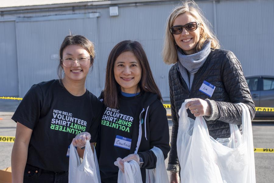 Smiling volunteers doing clean up.